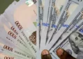 Dollar-to-Naira Exchange Rate Holds Near ₦1,340/$ Amid Mild Market FluctuationsThe naira traded within a relatively stable range against the United States dollar at the official market on Thursday, April 23, 2026, reflecting marginal movements in early trading activity.Data from the Nigerian Foreign Exchange Market (NFEM) showed that the local currency hovered around the mid-₦1,300 band per dollar, continuing a trend of slight fluctuations recorded in recent sessions. Market indicators point to modest volatility, with the naira maintaining a narrow trading corridor.In comparable recent sessions, the currency was quoted at an average of ₦1,347.33 per dollar, indicating a minor depreciation from previous closing levels. Meanwhile, earlier data showed the naira trading at approximately ₦1,345.47 per dollar during morning operations, reflecting a marginal appreciation at the time. Analysts note that the current movement underscores a largely stable foreign exchange market, supported by sustained liquidity and ongoing interventions by monetary authorities. Despite intermittent pressures driven by demand for foreign exchange, the naira has continued to show resilience within the official trading window.Market watchers expect the currency to remain within this range in the short term, barring any significant shocks from external or domestic economic factors.
